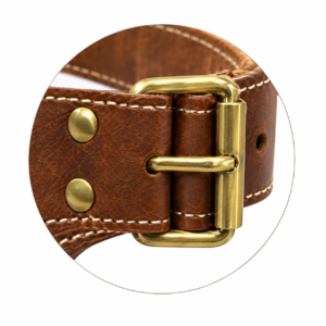 Close-up of the antique brass buckle on a premium brown leather garden tool belt, showcasing polished gold-tone metal hardware, reinforced leather loops, secure brass rivets, and precise cream-colored stitching. Highlights the durable construction and fine craftsmanship of John Leatherwear.